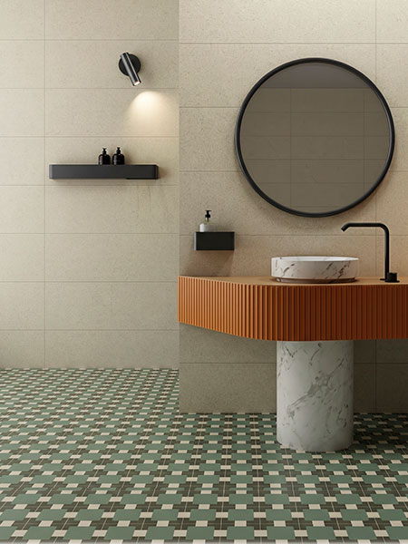 Azulejo porcelánico Mele de la serie Surf en tonos verde, gris y beige con diseño geométrico para suelo de baño moderno.
