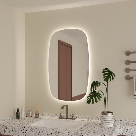 Espejo de bano Wine con forma organica y luz LED ambiental encendida sobre mueble de bano