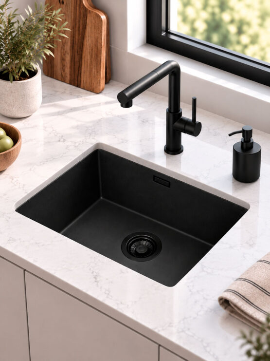 Fregadero negro rectangular de una cubeta bajo encimera blanca con grifo negro